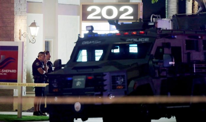 Police officers respond to the scene of a shooting in Orange