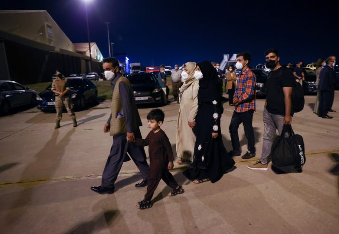Spanish and Afghan citizens who were evacuated from Kabul arrive at Torrejon airbase in Torrejon de Ardoz