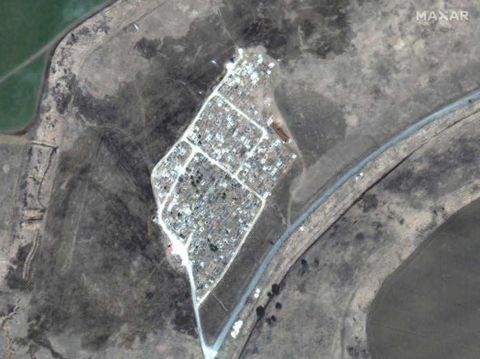 A satellite image shows the expansion of new graves at a cemetery in Vynohradne, near Mariupol