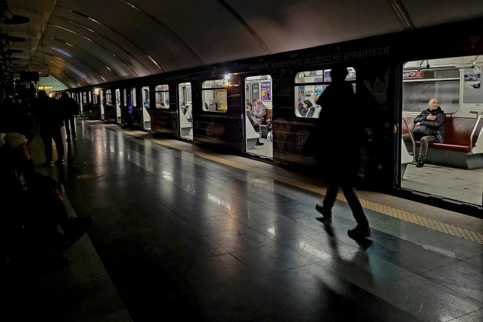 People take shelter inside the metro station during Russia's missile attacks in Kyiv