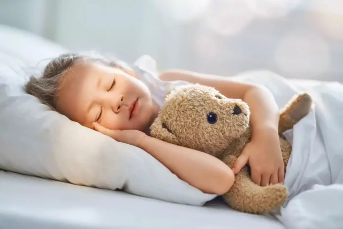 kid-sleeping-in-bed-1290x860