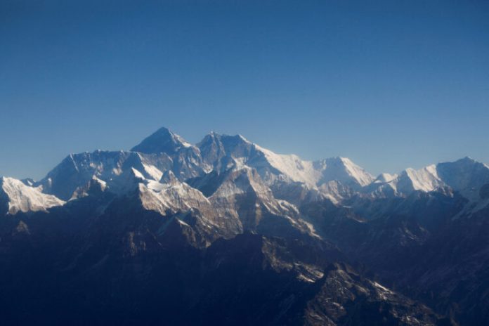 FILE PHOTO: FILE PHOTO: Mount Everest, the world highest peak, and other peaks of the Himalayan range are seen through an aircraft window during a mountain flight from Kathmandu
